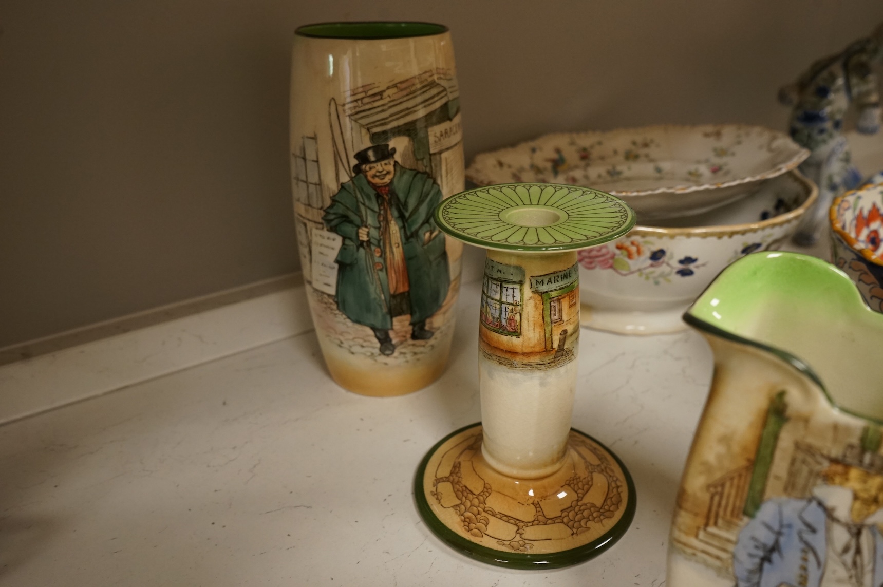 A collection of French, Japanese and English ceramics to include Royal Doulton Dickensware, Imari bowls and a faience glazed cat